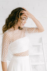 Modelo vestida como novia con un top de manga larga de flores, un tube top y un pantalón palazzo