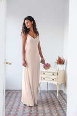 La modelo se para ligeramente de costado, mostrando el perfil del vestido de novia color champagne