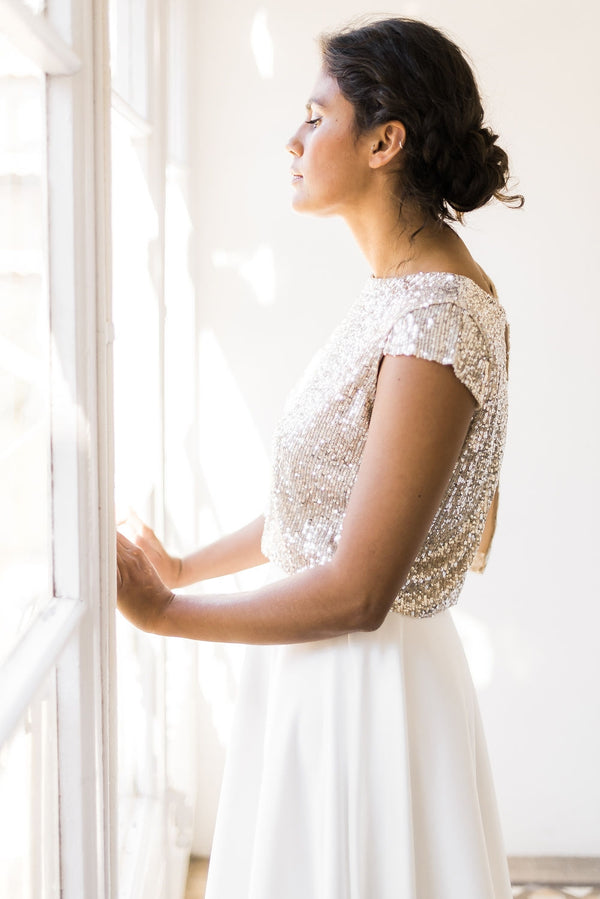 Perfil lateral de una novia luciendo un top de manga corta con lentejuelas